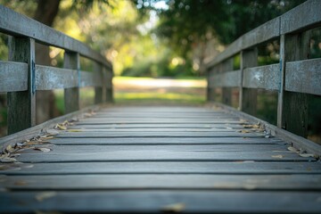 Fototapeta premium A wooden bridge surrounded by autumn leaves on the ground, perfect for nature and outdoor themed projects