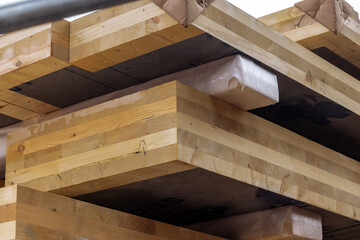 Close up detail of a pile of glue laminated floor and wall panels for sustainable,  green, multi...