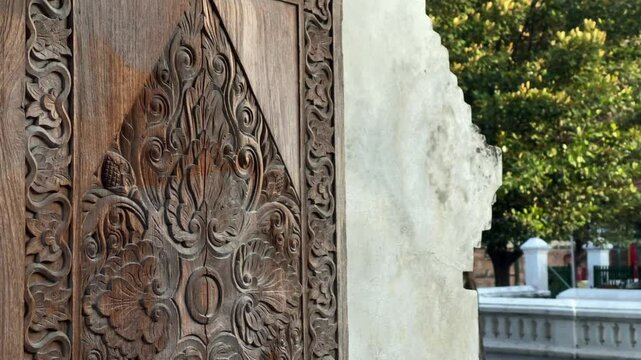 Artistic carvings of the wooden doors of the Kota Gede mosque in the style of Islamic, Javanese, Asian royal art.