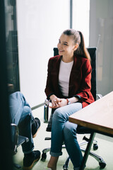 Friendly office workers talking behind glass door
