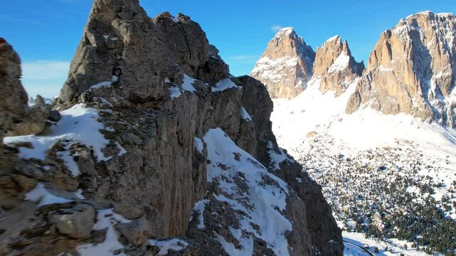 A epic stunning aerial view of the Dolomite Mountains in winter, showcasing their rugged beauty and snow-covered peaks of Dolomiti Superski