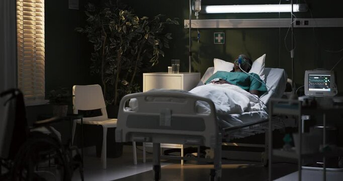 African woman in an oxygen mask is lying in a hospital room in a serious condition, in a coma, unconscious.