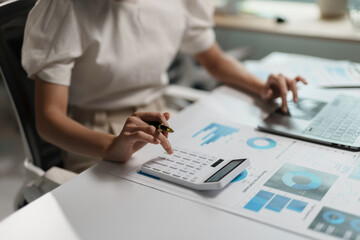 Businesswoman is calculating financial data for her company's growth and success