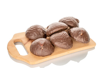 Marshmallow in chocolate on a wooden tray, macro, isolated on white background.