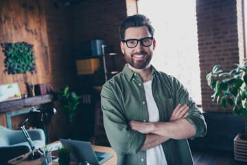 Photo of smart clever leader dressed shirt smiling arms crossed indoors workstation workshop