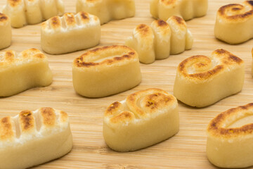 Marzipan figures on a wooden surface.