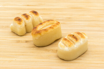 Marzipan figures on a wooden surface.