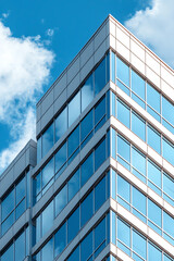 Modern architectural marvel a stylish glimpse of reflective glass and angled facades against the sky