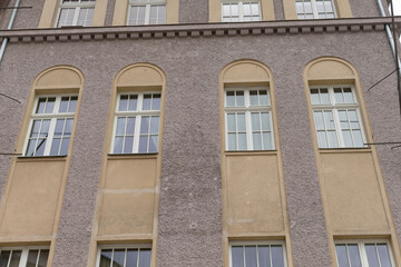 A large and impressive building featuring numerous windows throughout its facade, which enhances its architectural appeal and functionality