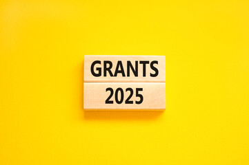 Planning grants 2025 new year symbol. Concept words Grants 2025 on beautiful wooden blocks. Beautiful yellow background. Business grants 2025 new year concept. Copy space.