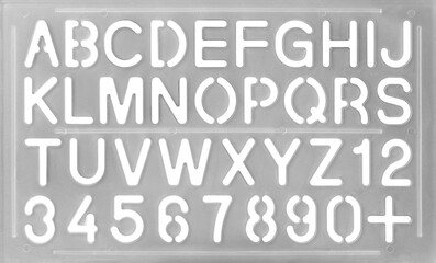 alphabet plastic stencil isolated white background, light gray english letter and number template, arts and crafts concept