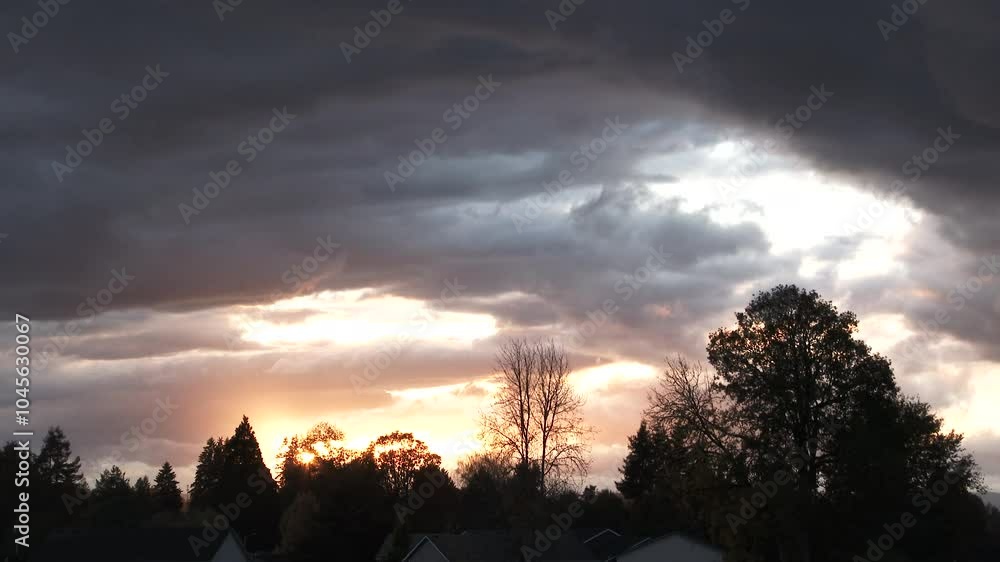 Canvas Prints amazing clouds showing the power of the sky and brilliant colors from the sun as it sets behind tree