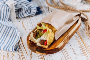 Falafel wrap with fresh vegetables and sauce, perfect vegan street food meal