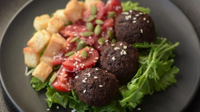 Hearty delicious fried falafel made from chickpeas, cumin, hummus with salt and spices on a dark concrete background