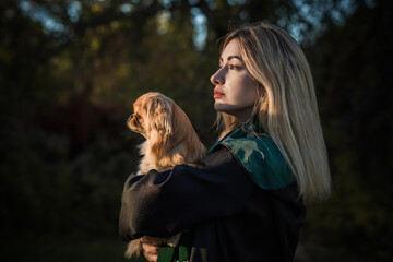 Woman with a nice pet in masquerade Halloween costume. Concept of wizard party