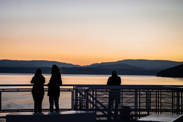 Silhouette on the ferry watching the sunset
