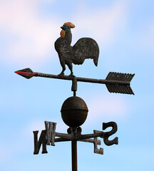 rooster weather vane with cardinal directions shows wind direction using an arrow to point the way the wind is blowing © ChiccoDodiFC