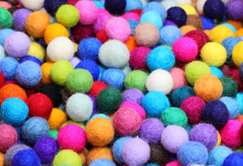 background of colorful felted wool balls for creating fashion accessories and for hobbying