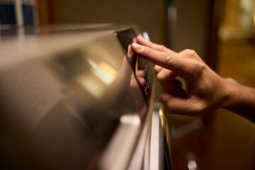 Hands Skillfully Adjusting the Washer Control in a Modern Domestic Laundry Room Environment