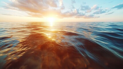 A serene ocean scene captures the golden glow of the sun setting on the horizon, creating a tranquil and mesmerizing seascape praised for its natural beauty.
