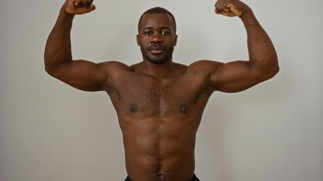 Young muscular man flexes his arms with confidence against a white background showcasing strength and fitness inspiration.