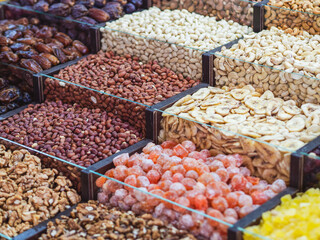 market stand with colorful dried fruits and nuts