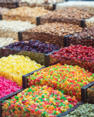 market stand with colorful dried fruits and nuts