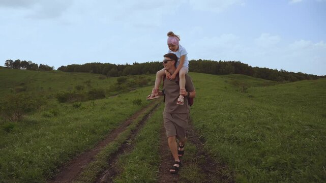 Dad carries his daughter across the river, dad carries his daughter in his arms