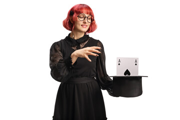 Female magician with a top hat performing a magic trick with a card