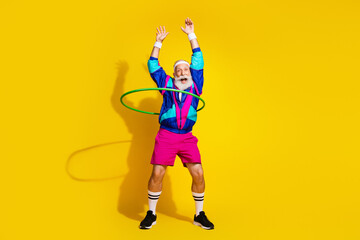 Full size photo of funky sporty man hula hoop spin empty space vintage sportswear isolated on...