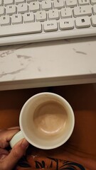 coffee cup and white computer keyboard in working time