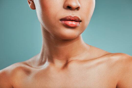 Beauty, collarbone and wellness with woman in studio isolated on blue background for hygiene closeup. Body, dermatology and skincare with model person at salon or spa for natural cosmetics treatment