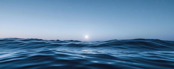 Fototapeta premium Peaceful moonlight touching the surface of a calm ocean, with small waves gently rolling under the starry night sky