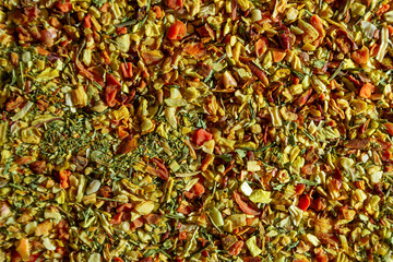 Vibrant and Colored Vegetable Seasoning Mix: A Culinary Canvas of Aromatic Seasoning - Textured Background for Gourmet Cooking. The Harmonious Combination of Fresh Herbs and Spices - Top View