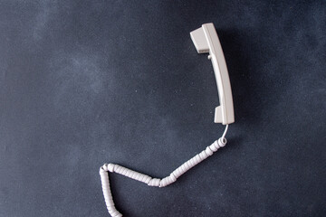 Telephone handset with cord. Old Phone. Black background copy space.