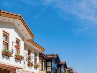 Roofs of several houses in perspective against blue sky with copy space in old town Side, architectural element with decorations, lifestyle in famous resort town