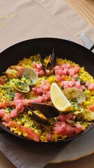 Seafood Paella with Shells and Lemon in Pan with Wine Glass