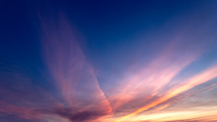 Sunset sky clouds in the evening with colorful orange, Yellow, pink and red sunlight and dramatic clouds on twilight sky,