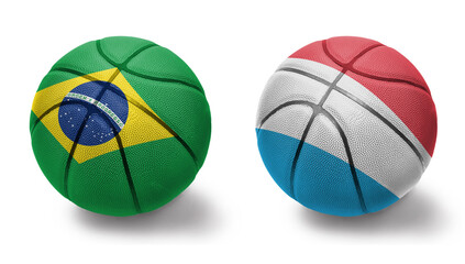 basketball balls with the national flags of luxembourg and brazil on the white background.