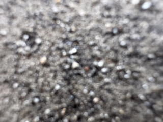 Defocused gray ash like sand from burning coal for background.