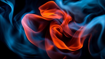 Obraz premium Abstract swirls of blue and orange smoke against a black background.