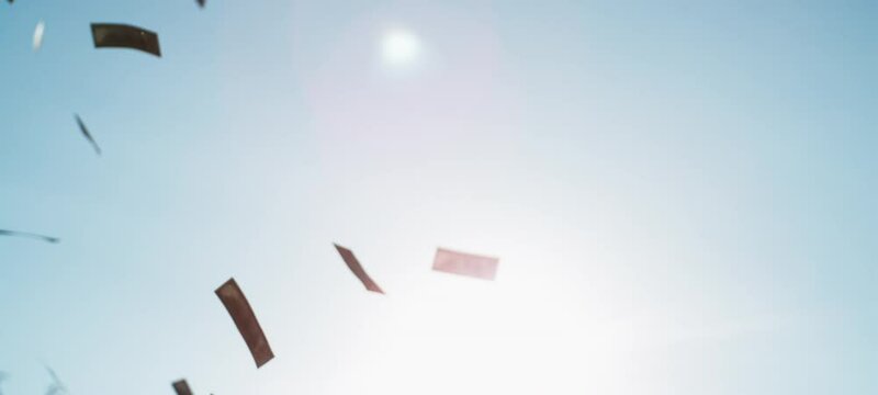 Money falling on sky background - Dollar paper bills raining down from top in slow-motion