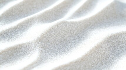 Close-up of soft, white sand with gentle waves.