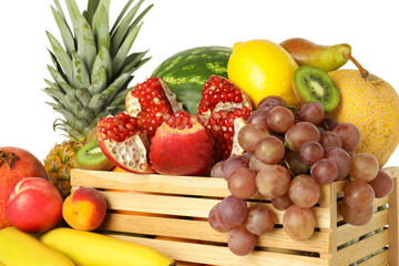 Wooden crate with many different fresh fruits on white background