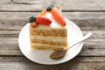 Piece of delicious carrot cake on wooden table, closeup
