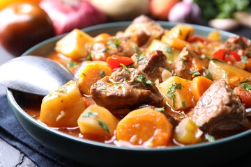 Delicious stew with vegetables on table, closeup