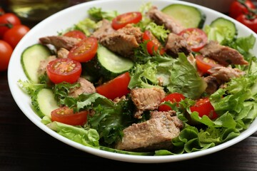 Delicious fresh tuna salad on wooden table, closeup