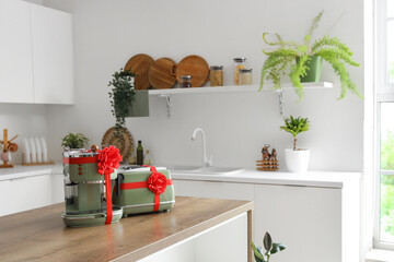 Different household appliances on counter as gift in kitchen