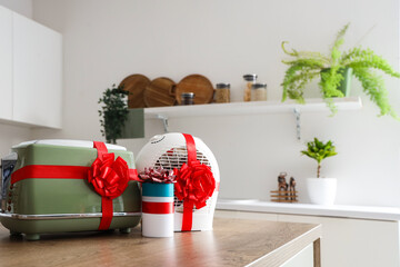 Different household appliances on counter as gift in kitchen