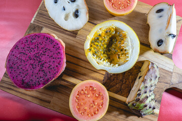 Different kind of tropical fruits, on a wooden background. Flatlay background.